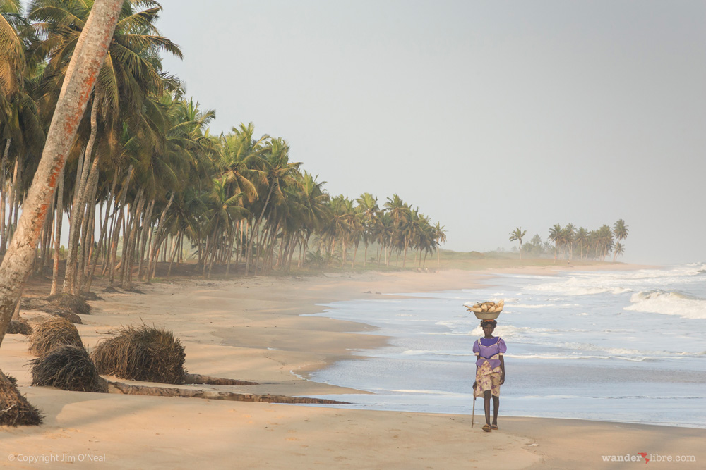 A girl walking on quiet beach in Ghana