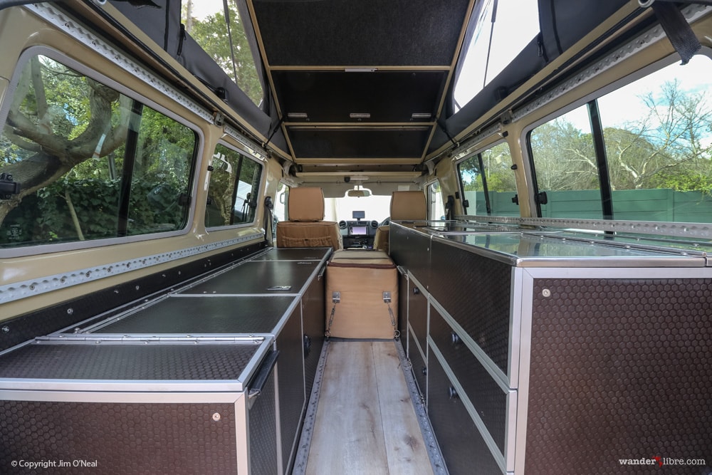 Toyota Land Cruiser Camper Living Area Showing Raised Pop-Top Roof, Bed Stowed, and Seat Cushions Removed