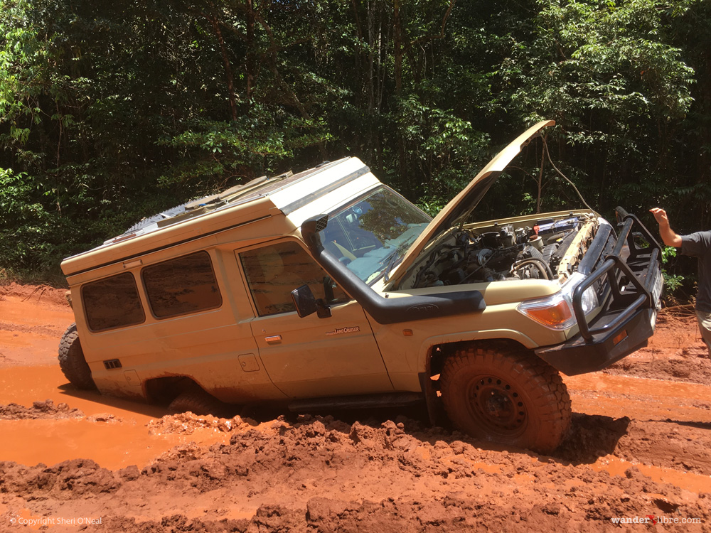 A photo of Maggie, our Land Cruiser Troopy, stuck in deep mud along the road from Georgetown to Lethem, Guyana.