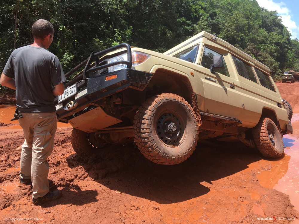 A photo of Maggie, our Land Cruiser Troopy, stuck in deep mud along the road from Georgetown to Lethem, Guyana.