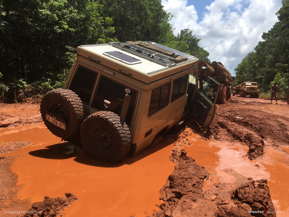 A photo of Maggie, our Land Cruiser Troopy, stuck in deep mud along the road from Georgetown to Lethem, Guyana.