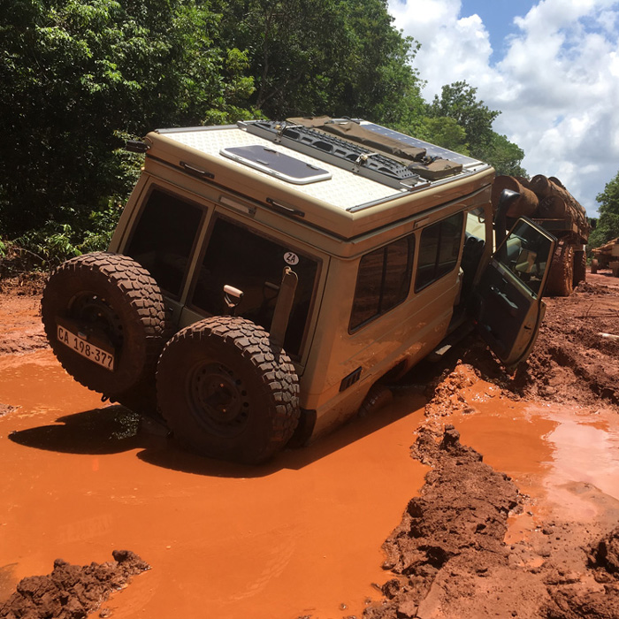 A photo of Maggie, our Land Cruiser Troopy, stuck in deep mud along the road from Georgetown to Lethem, Guyana.