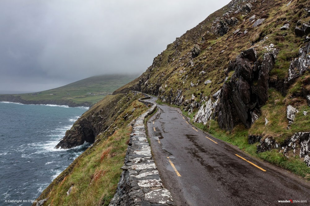 Driving the Dingle Peninsula's stunning cliff-lined coast near Killarney in Southern Ireland.