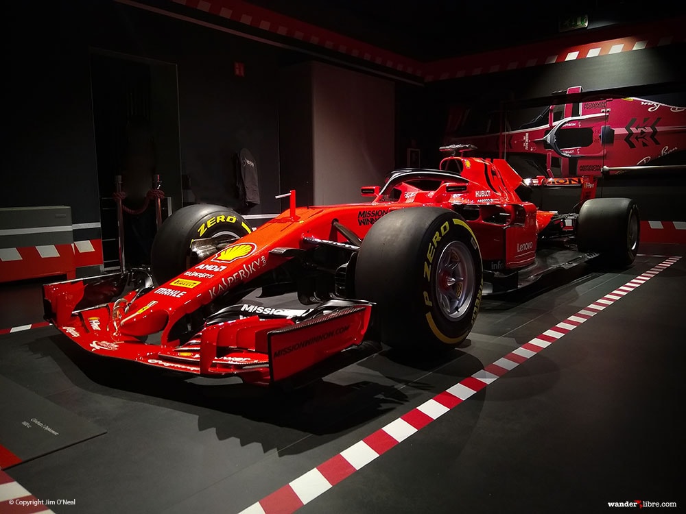 A side profile of a 2018 Ferrari Formula 1 race car on display at the Ferrari Museum in Maranello, Italy.