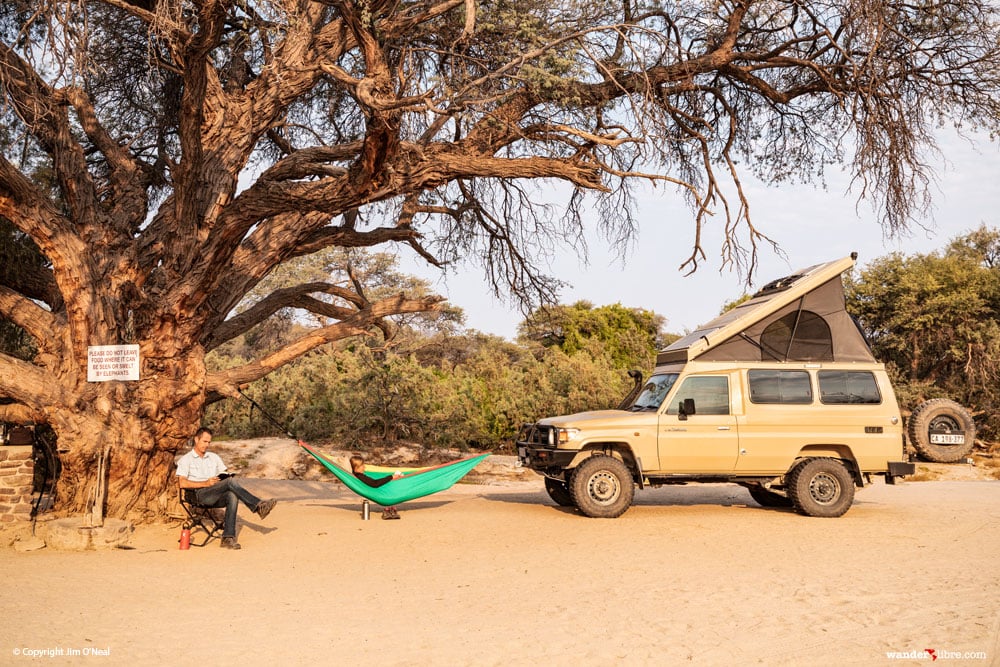 A campsite photo that shows the Front Runner Expander Chair and a Eno SingleNest Hammock